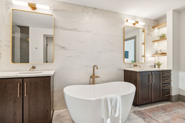 bathroom featuring tile walls, a washtub, and vanity