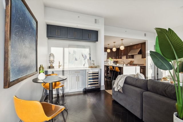 bar featuring wine cooler, sink, plenty of natural light, backsplash, and dark parquet flooring