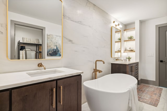 bathroom with vanity and a bath