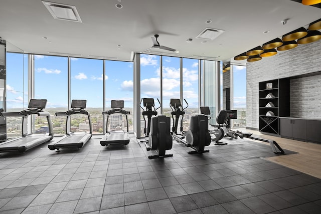 gym featuring ceiling fan and a wall of windows