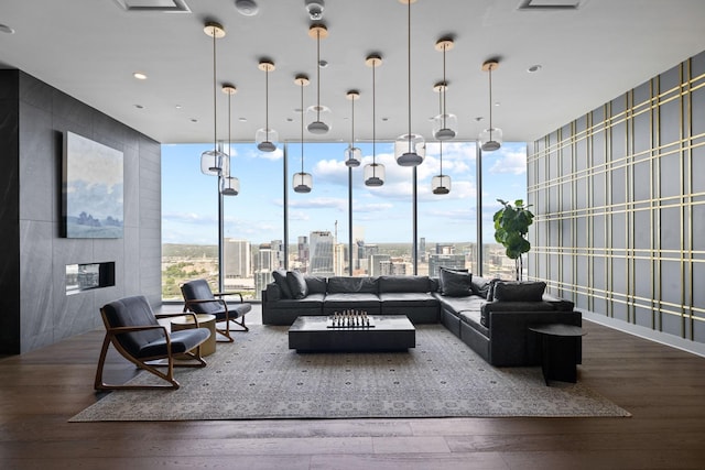 1616 W End Ave Unit 2911, Nashville, TN 37203 - living room with wallpapered walls, hardwood / wood-style flooring, expansive windows, a city view, and a glass covered fireplace