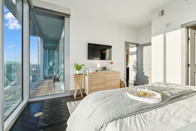 bedroom featuring access to exterior and dark hardwood / wood-style flooring