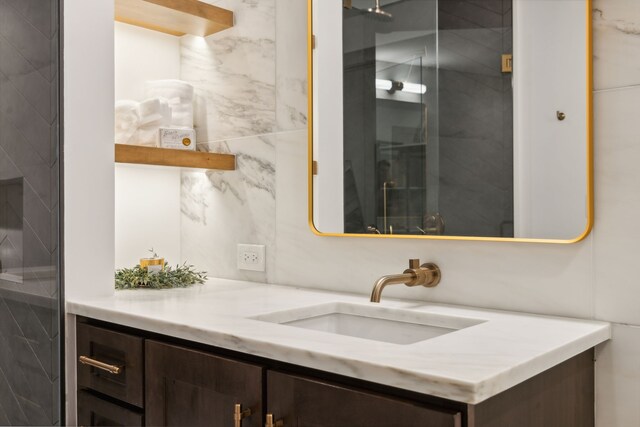 bathroom featuring tile walls and vanity