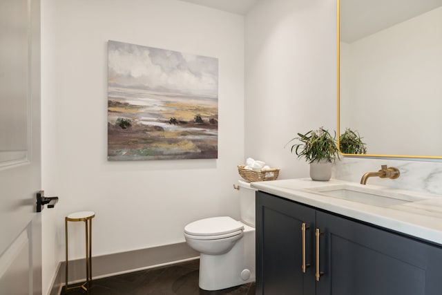 bathroom featuring vanity and toilet