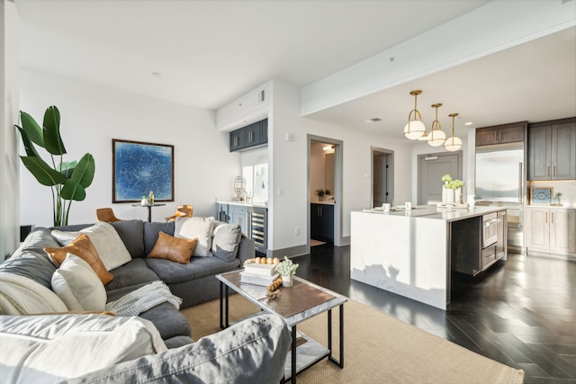 living room with dark hardwood / wood-style flooring and beverage cooler