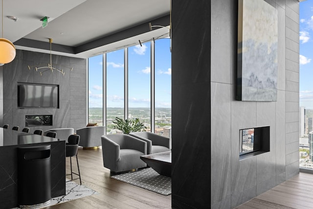 1616 W End Ave Unit 2911, Nashville, TN 37203 - living room featuring wood finished floors, a glass covered fireplace, and floor to ceiling windows