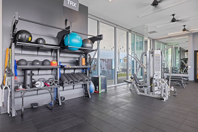 workout area with a wall of windows and ceiling fan