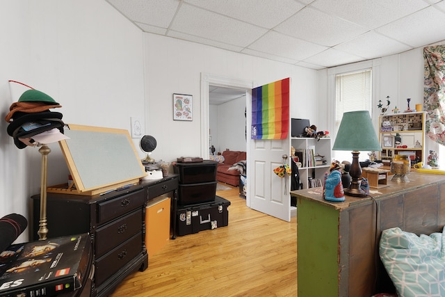 office area featuring a drop ceiling and light hardwood / wood-style floors