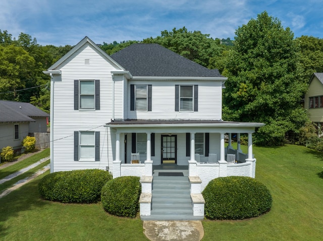 view of front of home with a front yard and covered porch