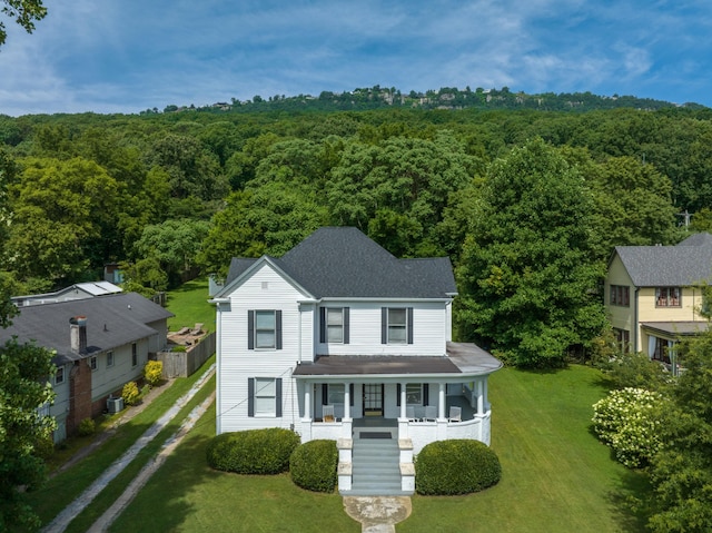 view of front of property with a front lawn, central AC, and a porch