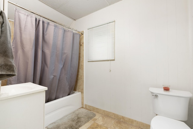 full bathroom with toilet, tile patterned flooring, wooden walls, vanity, and shower / tub combo with curtain