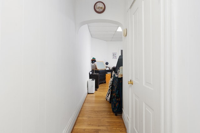 hallway with light hardwood / wood-style floors