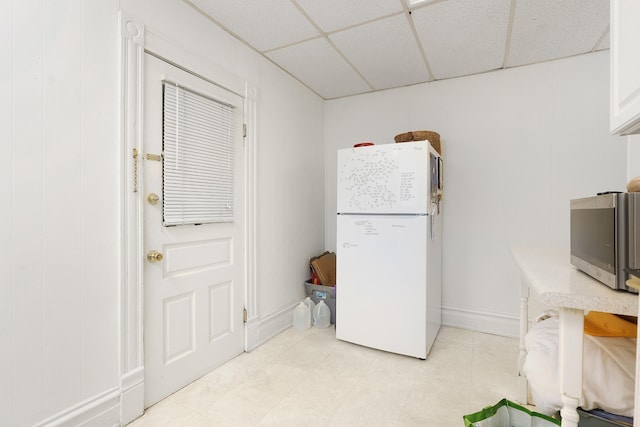 kitchen with white fridge and a drop ceiling