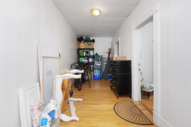 corridor featuring wood walls and wood-type flooring