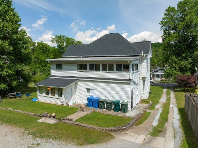 rear view of house with a yard