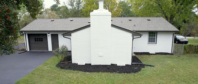 view of home's exterior featuring a lawn and a garage