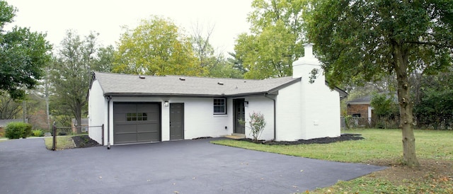 ranch-style home with a garage and a front yard