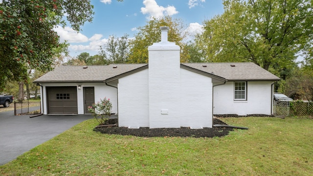 exterior space with a garage and a yard