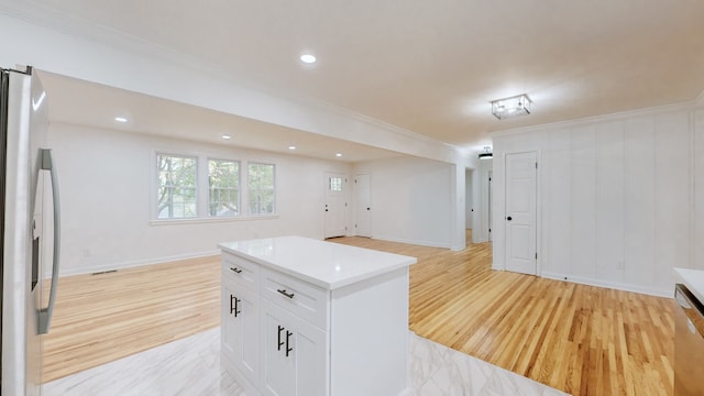 kitchen with light hardwood / wood-style floors, white cabinetry, stainless steel refrigerator with ice dispenser, and a center island