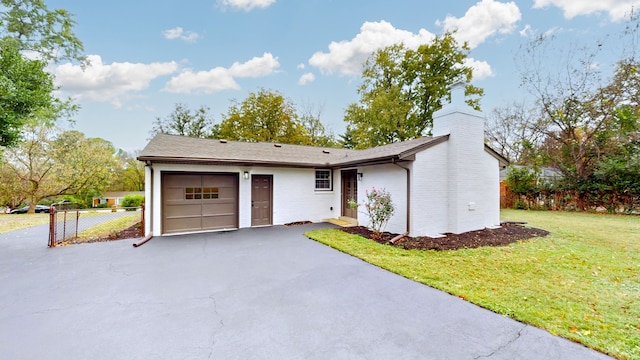 ranch-style house with a garage and a front yard