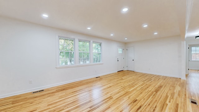 empty room with light hardwood / wood-style flooring