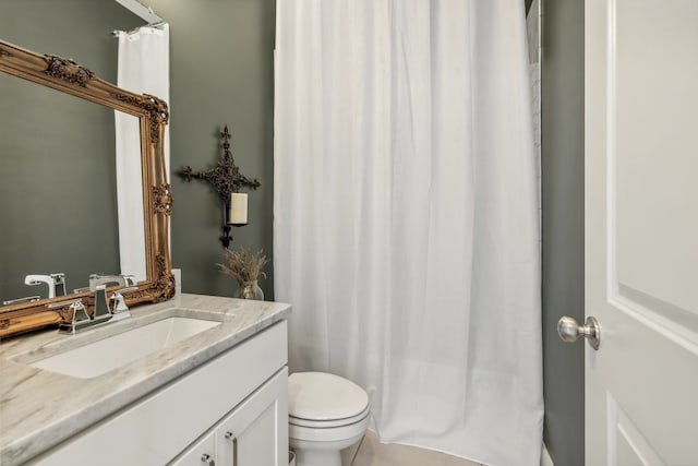 bathroom featuring toilet, vanity, and tile patterned flooring