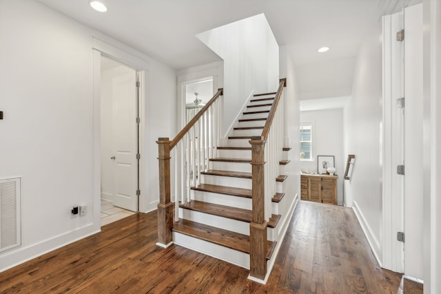 stairs featuring wood-type flooring