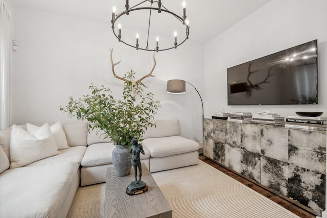 living room featuring wood-type flooring and a notable chandelier