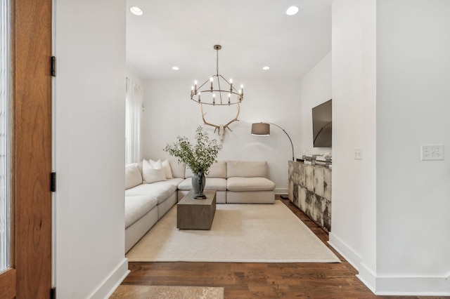 living room with wood-type flooring and a chandelier