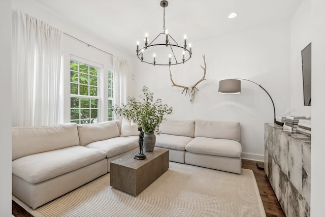 living room with hardwood / wood-style flooring and an inviting chandelier