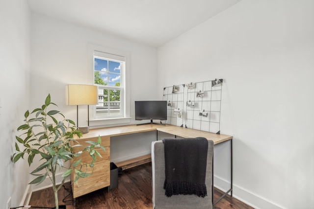 home office with dark hardwood / wood-style floors