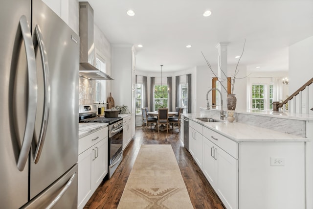 kitchen with dark hardwood / wood-style flooring, a healthy amount of sunlight, sink, and appliances with stainless steel finishes