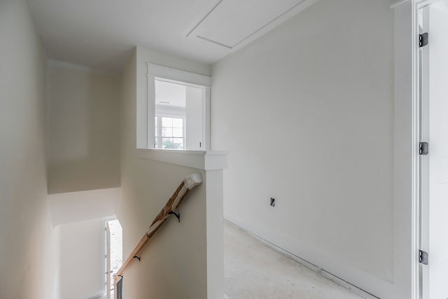 stairway featuring concrete flooring