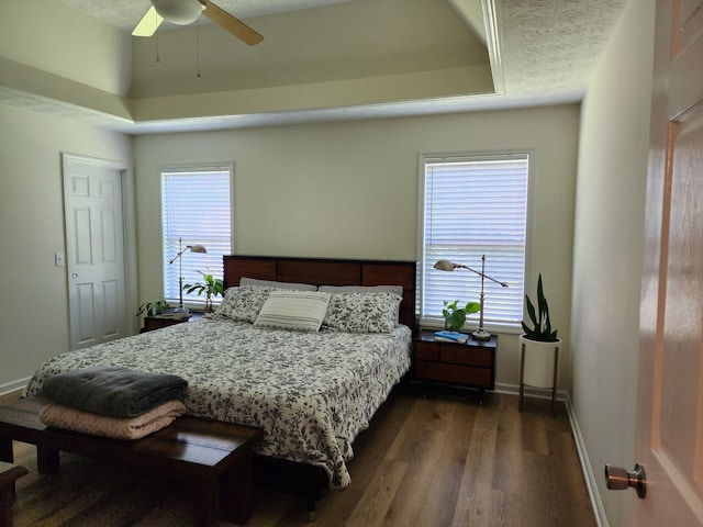 bedroom featuring a textured ceiling, ceiling fan, and dark hardwood / wood-style floors