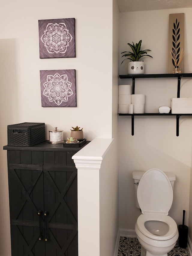 bathroom featuring tile patterned flooring and toilet