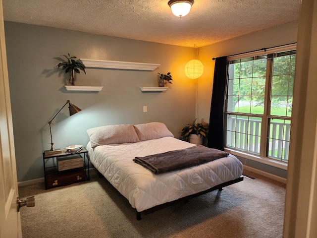 carpeted bedroom featuring a textured ceiling