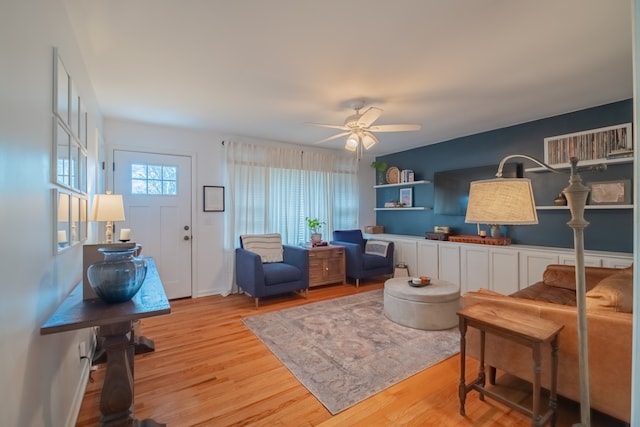 living room featuring ceiling fan and light wood-type flooring