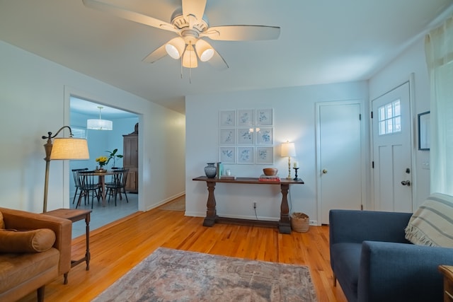 living room featuring wood-type flooring and ceiling fan