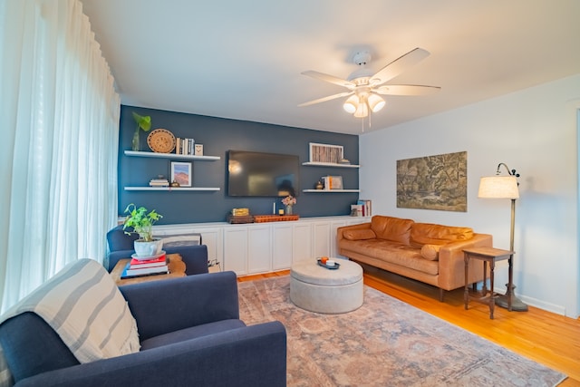 living room with hardwood / wood-style floors and ceiling fan