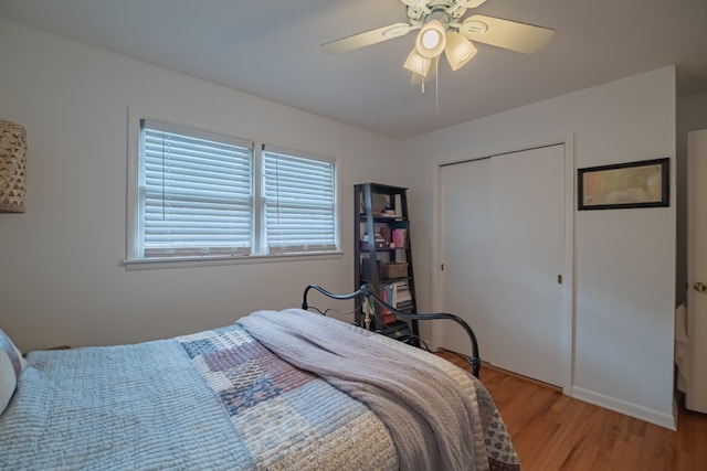 bedroom featuring light hardwood / wood-style flooring, ceiling fan, and a closet