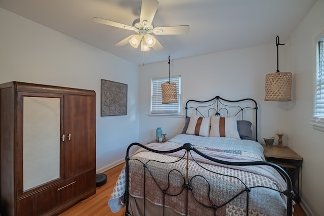 bedroom with light hardwood / wood-style flooring and ceiling fan