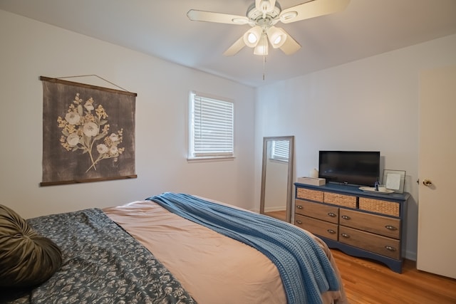 bedroom with hardwood / wood-style floors and ceiling fan