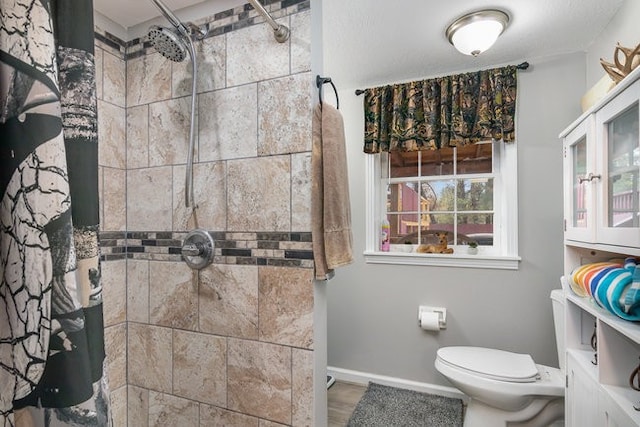 bathroom with toilet and a shower with curtain