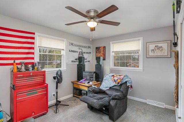 sitting room featuring ceiling fan and carpet flooring