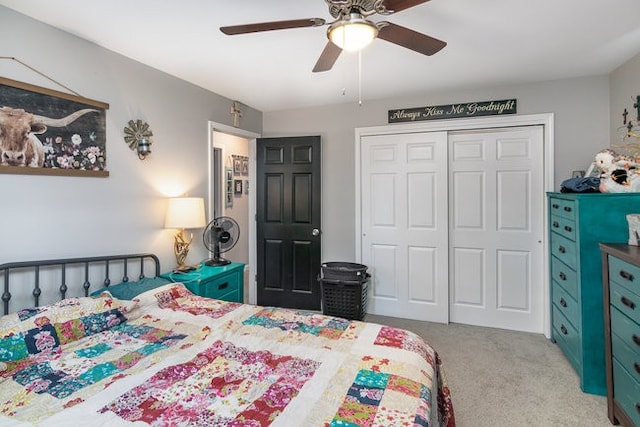 carpeted bedroom featuring ceiling fan and a closet