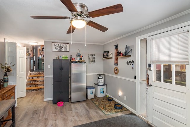 misc room featuring ceiling fan, ornamental molding, and light hardwood / wood-style flooring