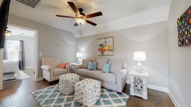 living room with dark hardwood / wood-style flooring and ceiling fan