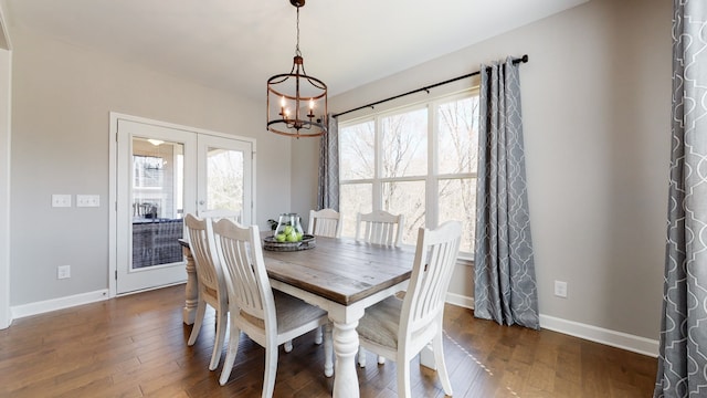 dining area with a chandelier, french doors, and dark hardwood / wood-style floors