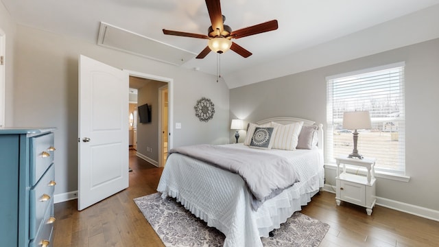 bedroom with vaulted ceiling, ceiling fan, and dark hardwood / wood-style flooring