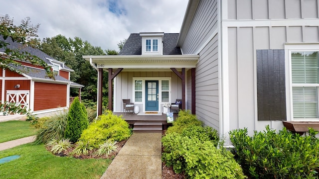 view of exterior entry with covered porch